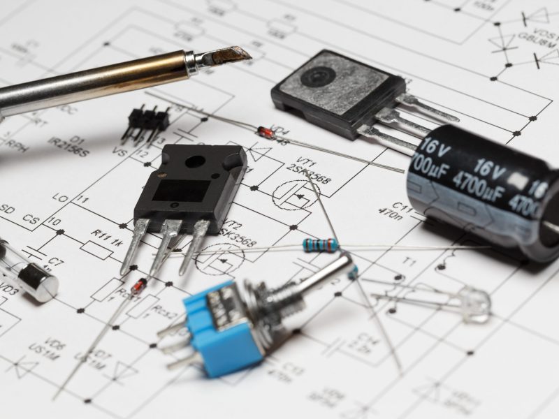 Various,Radio,Components,And,A,Soldering,Iron,Lie,On,A